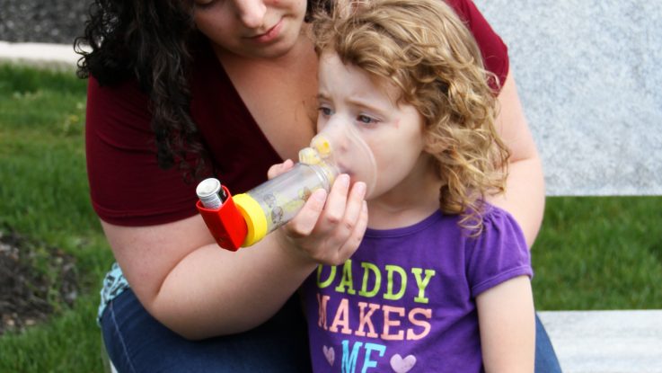 Joyce Kelso gives her 3 year old daughter, Karma, asthma medication through an inhaler in Columbus, Ohio.